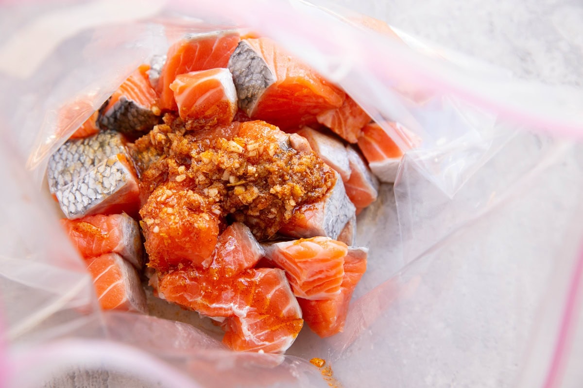 Salmon bites in a zip lock bag with marinade poured in.